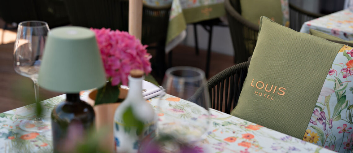 : © Tony Gigov A floral tablecloth and table decorations, plus a variety of seating options on the roof terrace.