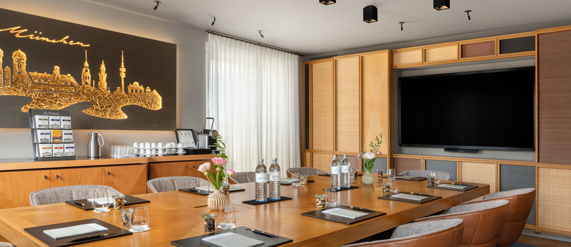 : © Tony Gigov A bright meeting room with warm wooden accents.