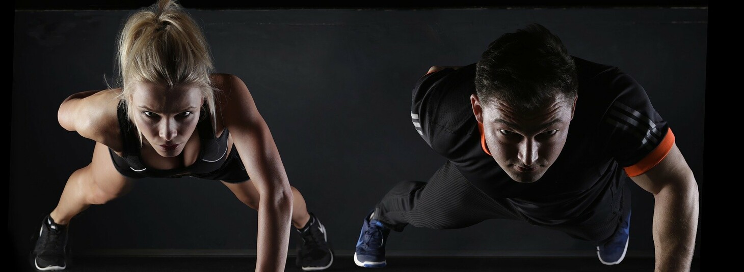 Woman and man are doing push ups