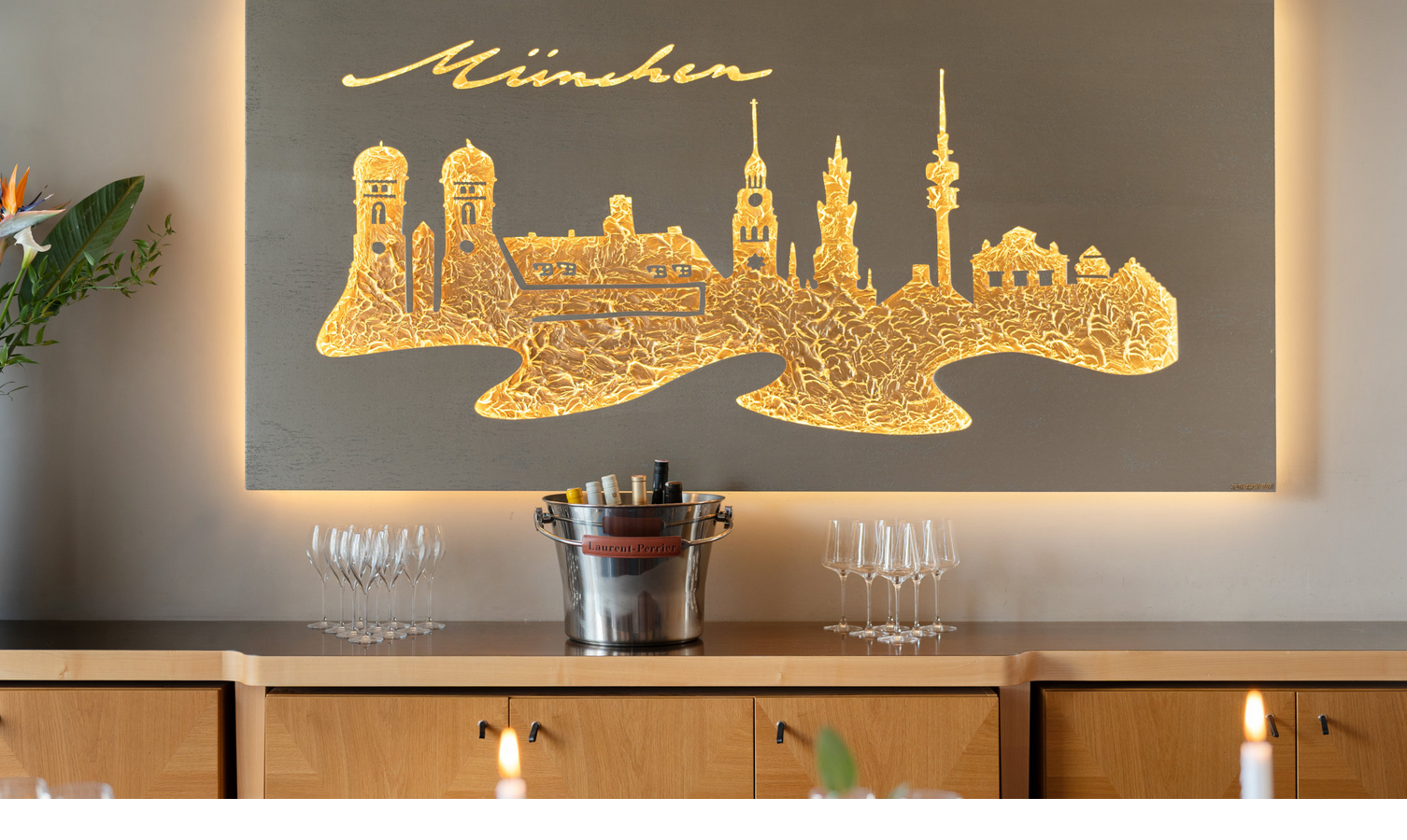 Ein Kunstwerk aus Metall mit der Skyline von München an der Wand.
