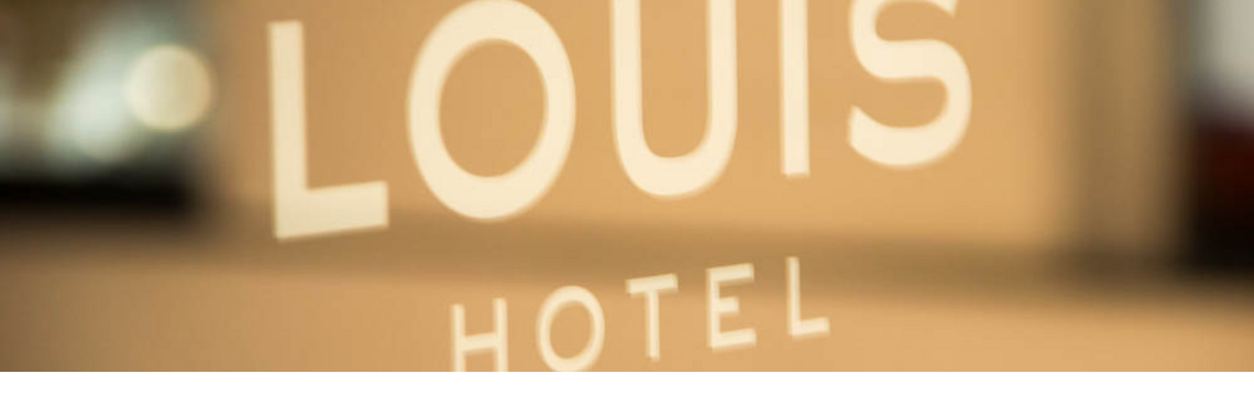 Logo on glass door LOUIS Hotel Munich