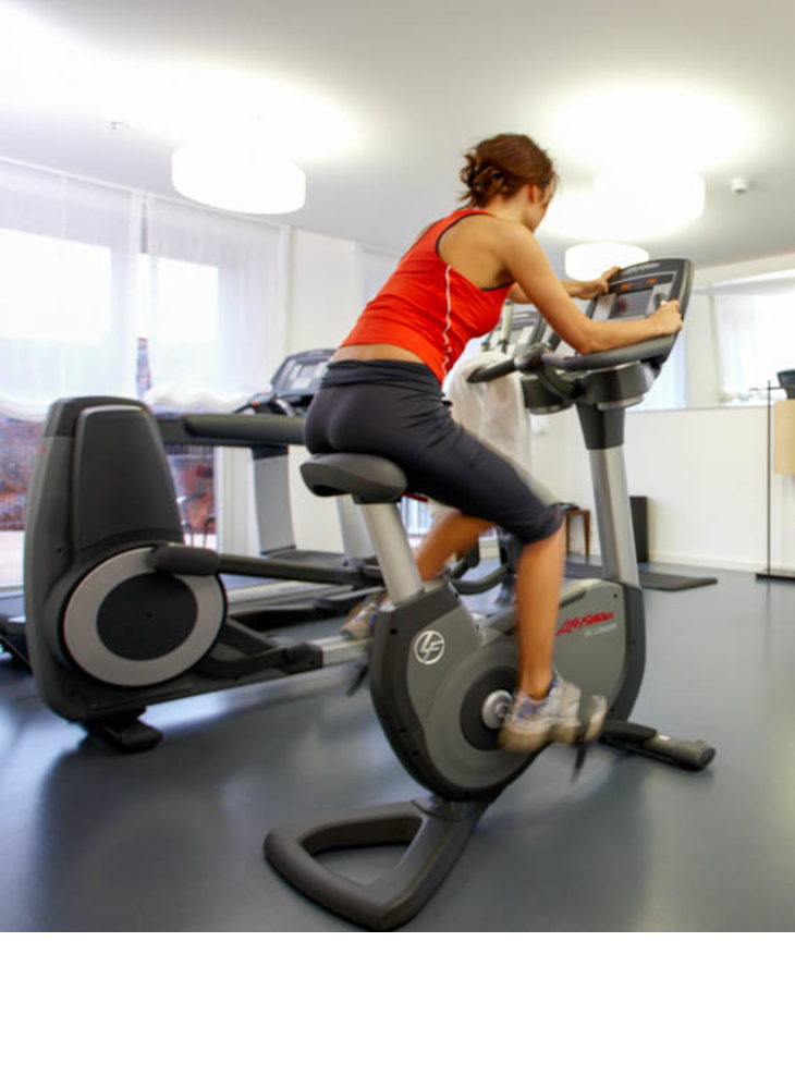 Women on spinning bike in LOUIS Hotel Fitness Room Gym in Hotel