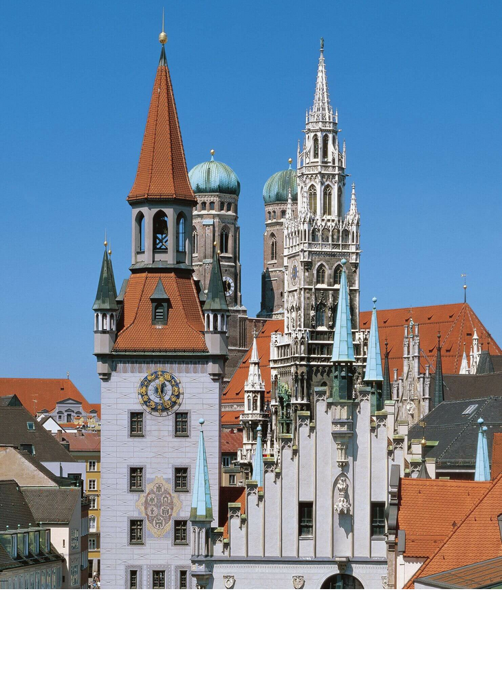 Vier Münchner Türme by the Marienplatz View of Munich's old town with historic towers and red roofs against a clear blue sky.